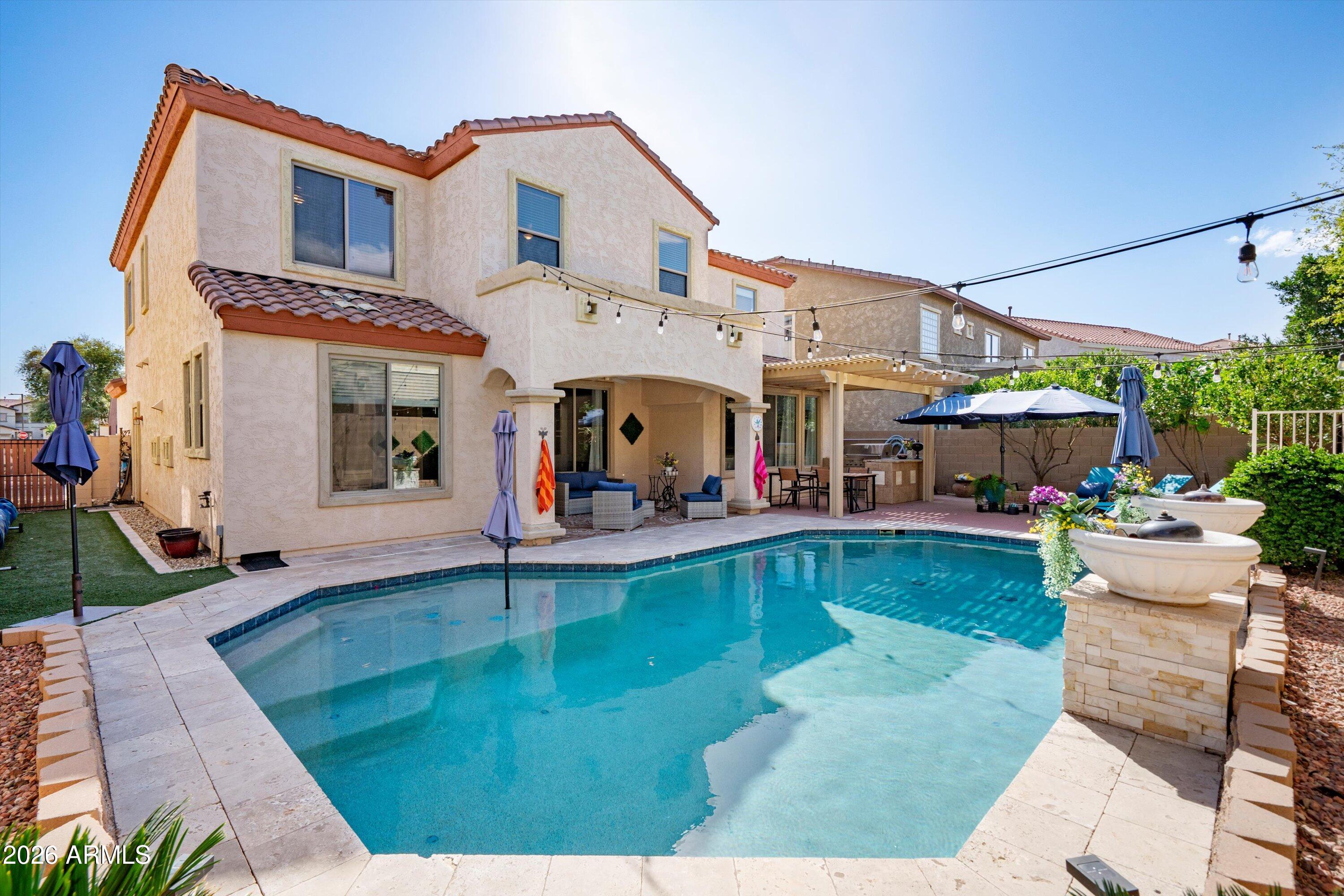 16018 West Shangri La Road Surprise, AZ 85379 - Photo 7 of 40 a view of a house with swimming pool patio and a yard
