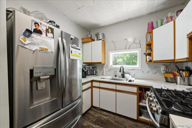 a kitchen with stainless steel appliances a sink stove and refrigerator