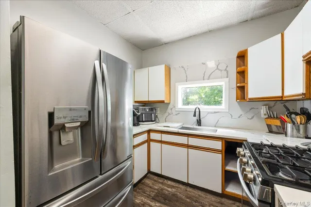 a kitchen with a refrigerator and a sink