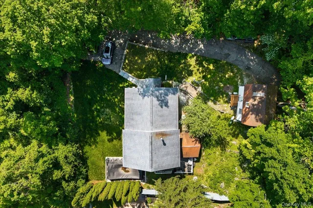 an aerial view of a house with yard and swimming pool