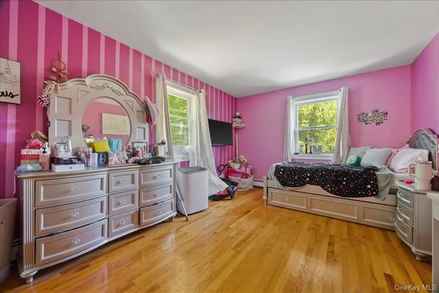 a kitchen with a stove a faucet a window and cabinets