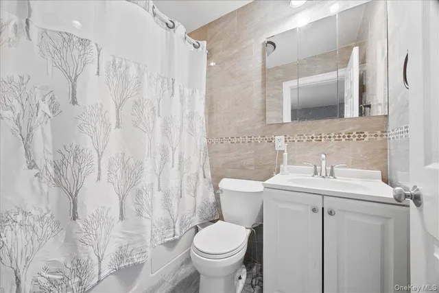 a bathroom with a toilet sink and a mirror