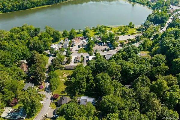 an aerial view of a house with a yard and lake view