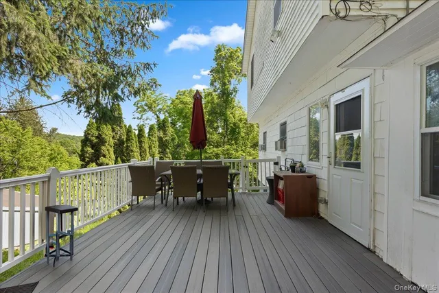 a view of balcony with furniture and wooden floor