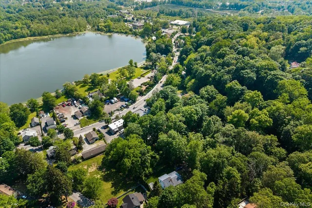 an aerial view of a houses with a lake view