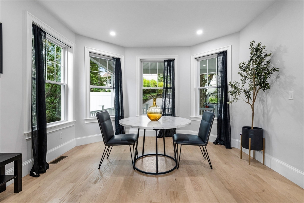 31 Rodman Street, Unit 2 Boston, MA 02130 - Photo 11 of 40 a dining room with wooden floor and windows