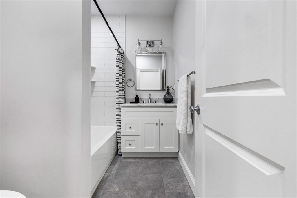 31 Rodman Street, Unit 2 Boston, MA 02130 - Photo 15 of 40 a utility room with cabinets washer and dryer