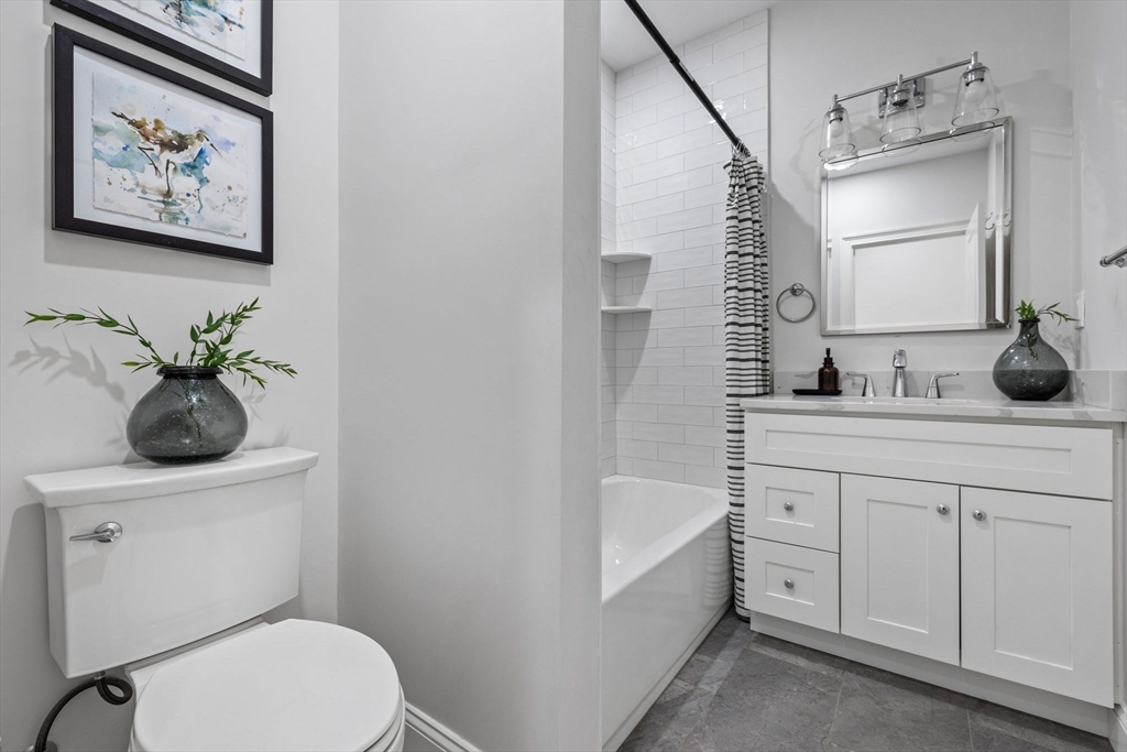 31 Rodman Street, Unit 2 Boston, MA 02130 - Photo 16 of 40 a bathroom with a toilet a sink and mirror