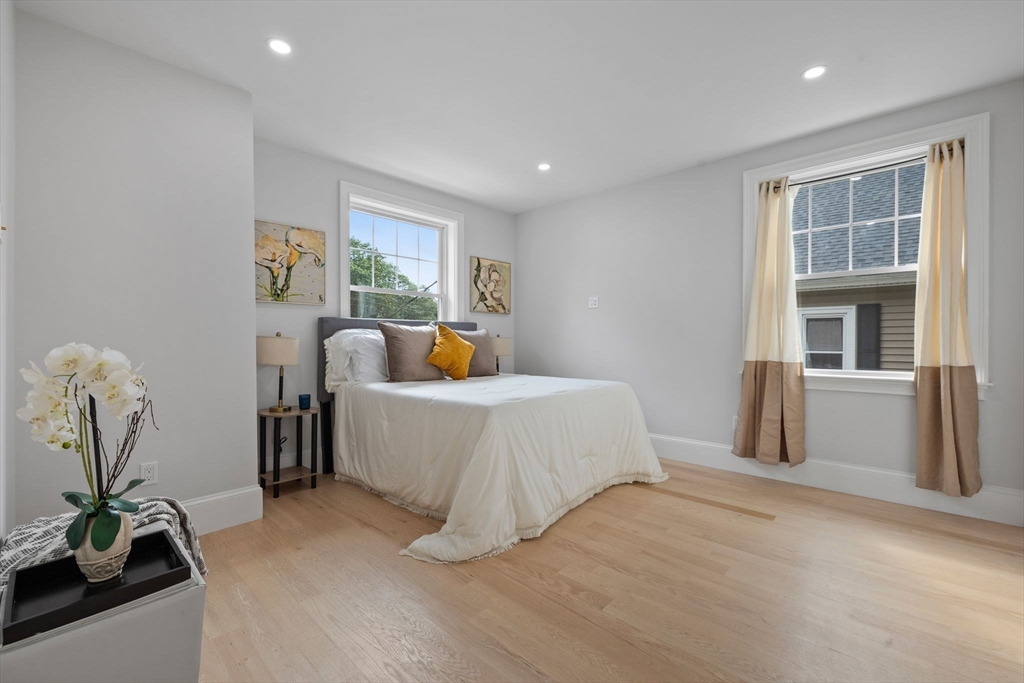 31 Rodman Street, Unit 2 Boston, MA 02130 - Photo 17 of 40 a bed room with a bed and a potted plant