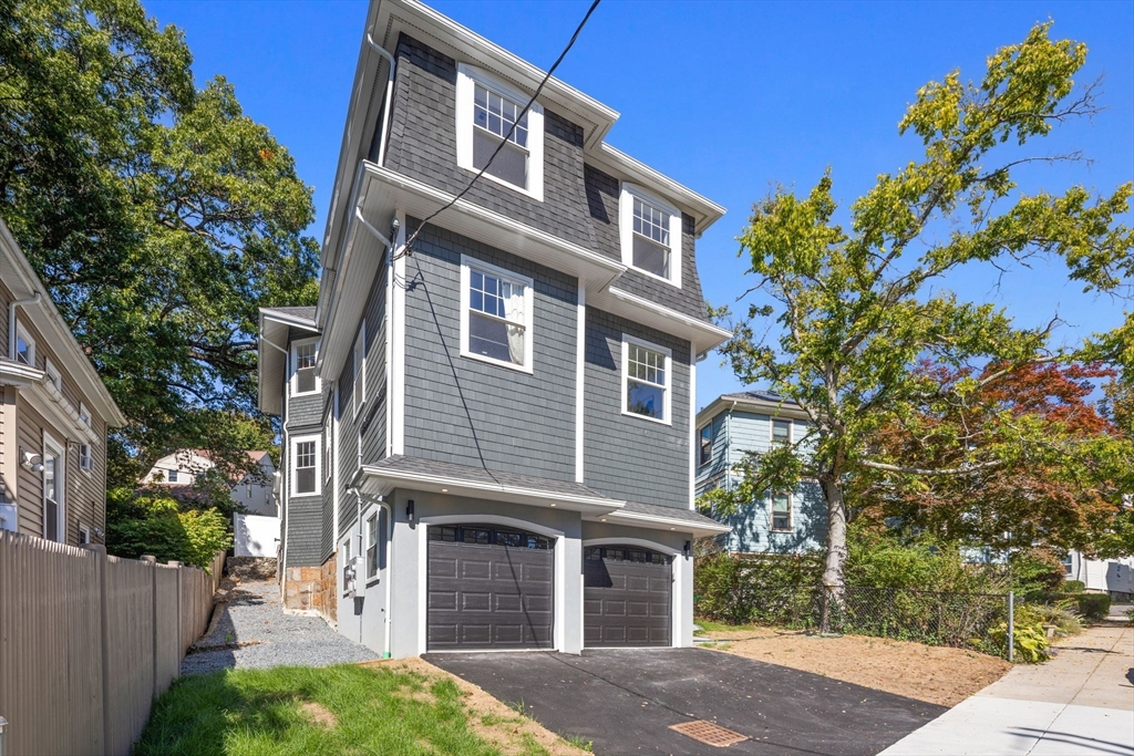 31 Rodman Street, Unit 2 Boston, MA 02130 - Photo 31 of 40 a front view of a house with a garden