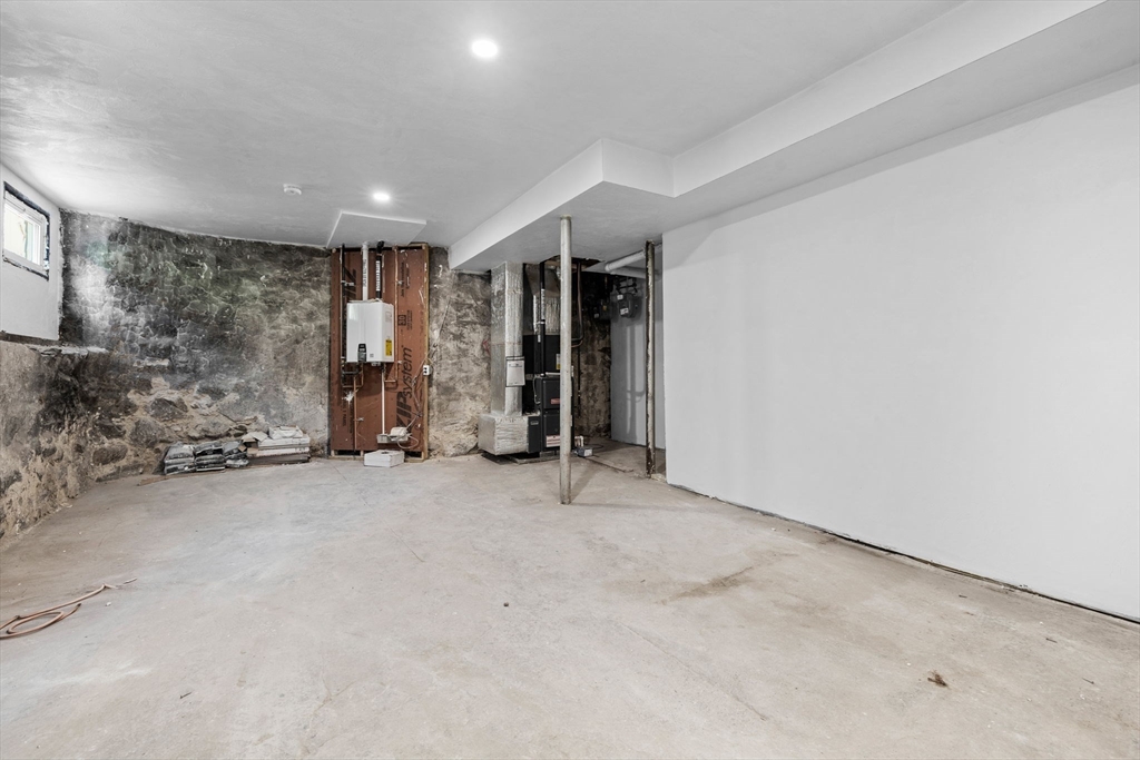 31 Rodman Street, Unit 2 Boston, MA 02130 - Photo 33 of 40 an empty room with fireplace and bathroom