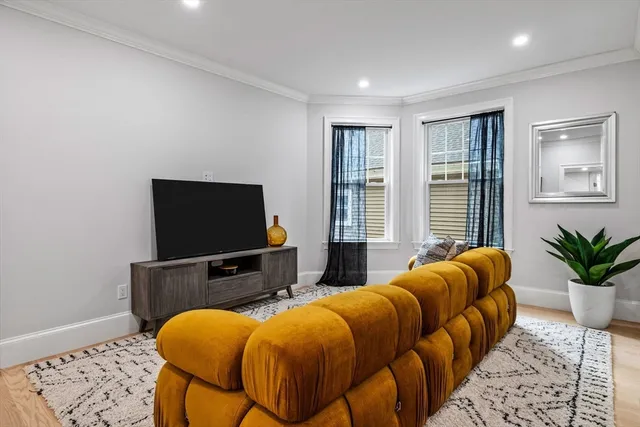 a bedroom with furniture and a flat screen tv