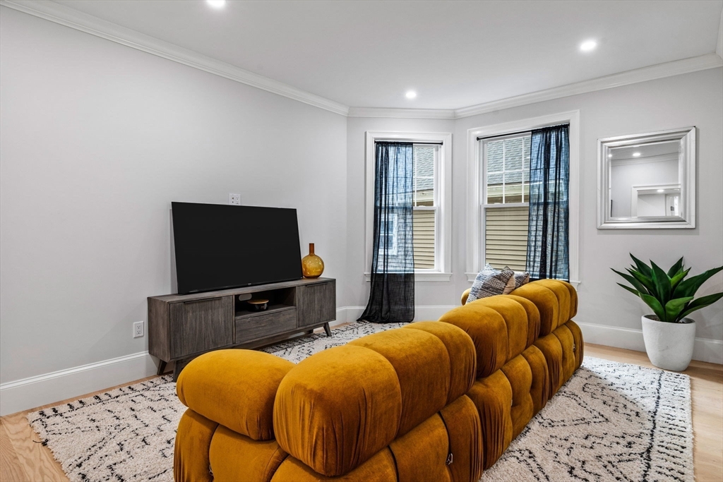 31 Rodman Street, Unit 2 Boston, MA 02130 - Photo 10 of 40 a bedroom with furniture and a flat screen tv