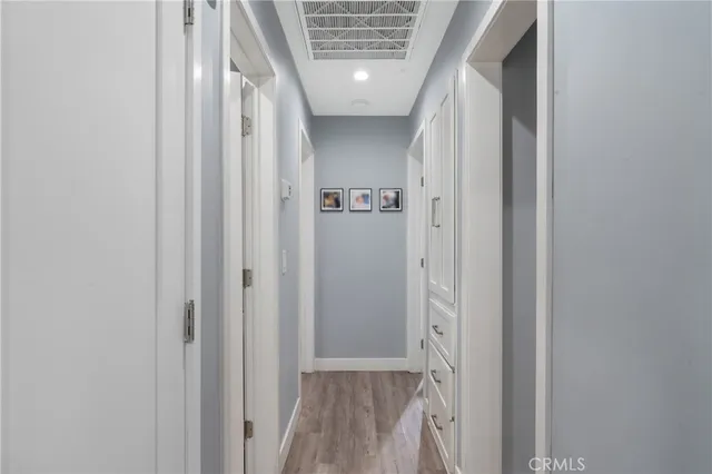 a view of a hallway with wooden floor and entryway
