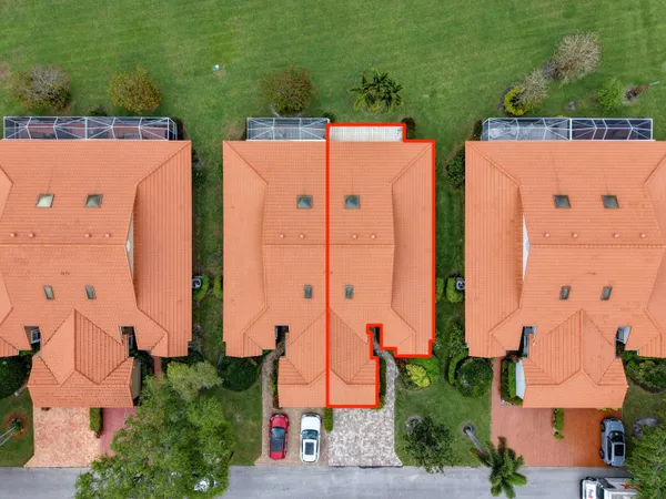 an aerial view of a residential apartment building with a yard