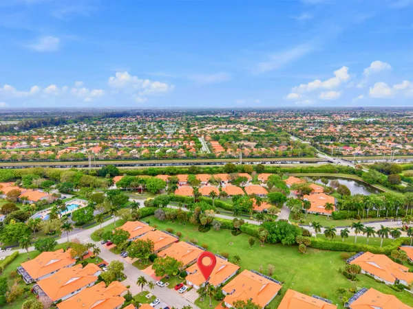 an aerial view of residential houses with outdoor space and lake view