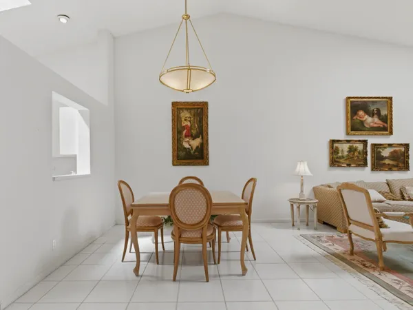 a view of a dining room with furniture and a chandelier
