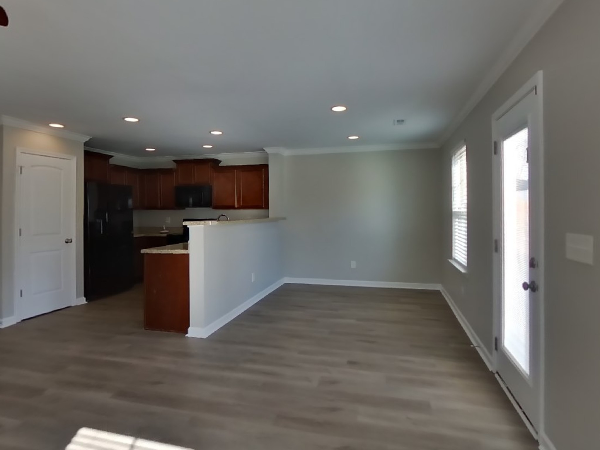 7100 Colquitt Way Fairview, TN 37062 - Photo 5 of 15 a view of a big room with wooden floor a kitchen and windows