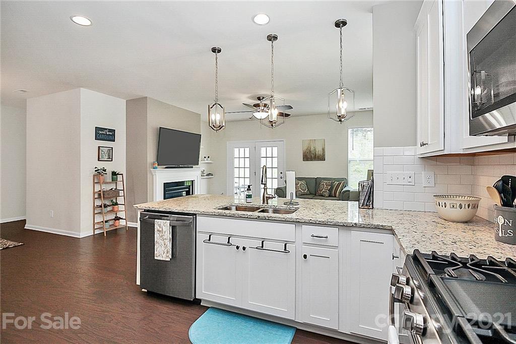 7131 Chrysanthemum Road Lancaster, SC 29720 - Photo 12 of 33 a kitchen with kitchen island granite countertop a sink cabinets and stainless steel appliances