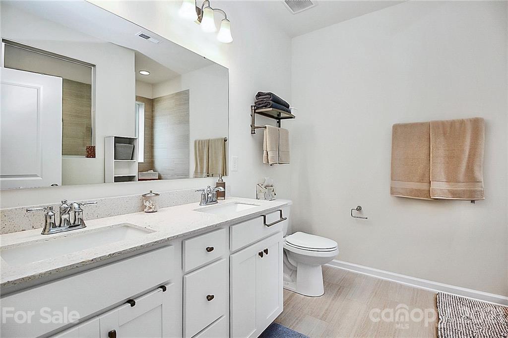 7131 Chrysanthemum Road Lancaster, SC 29720 - Photo 17 of 33 a bathroom with a double vanity sink mirror and toilet