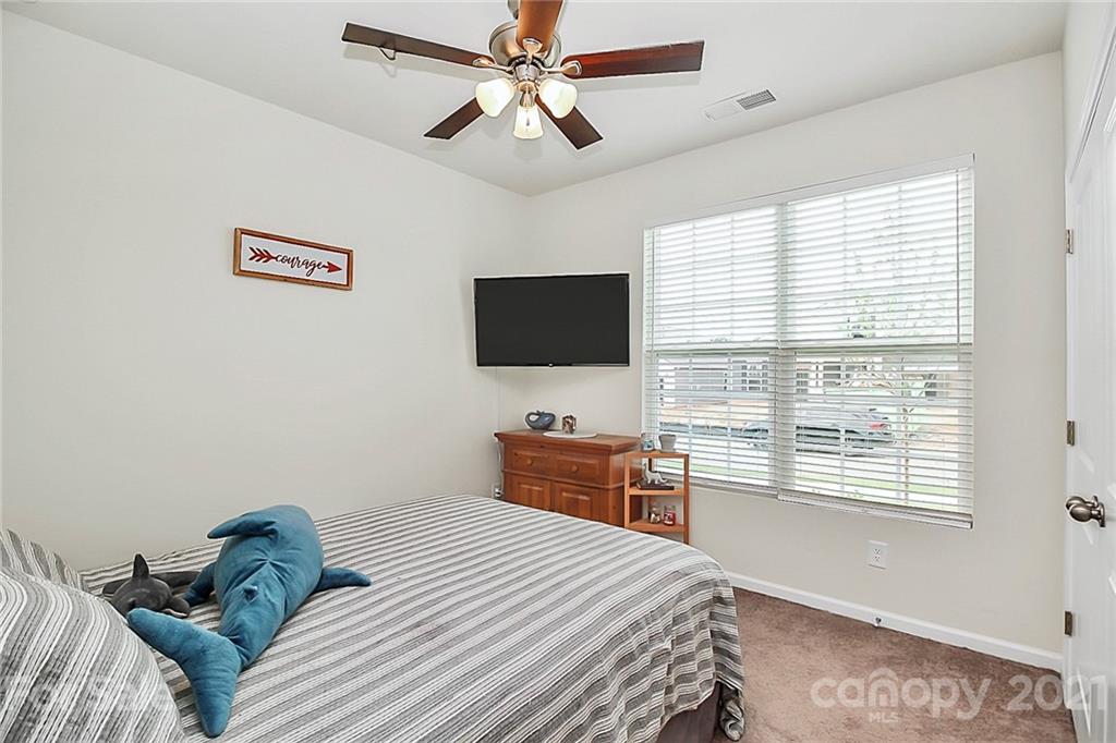 7131 Chrysanthemum Road Lancaster, SC 29720 - Photo 23 of 33 a bedroom with a bed and a flat screen tv