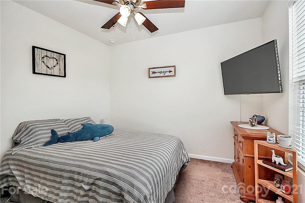 7131 Chrysanthemum Road Lancaster, SC 29720 - Photo 24 of 33 a bedroom with a bed and a flat screen tv