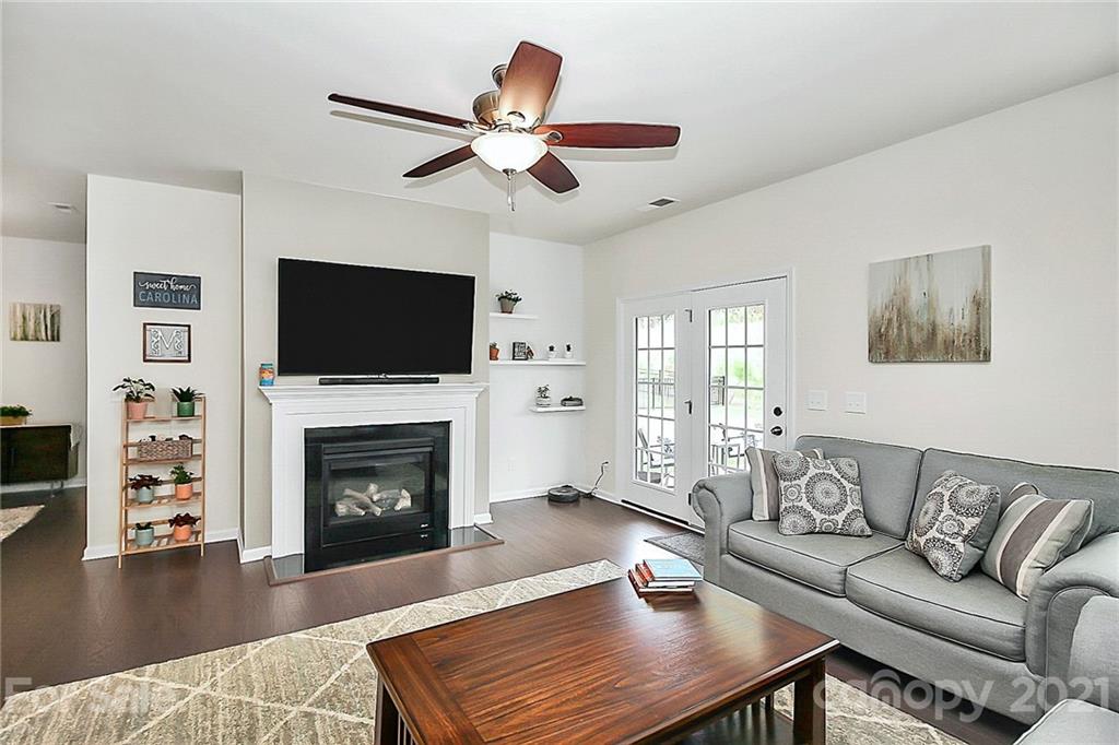 7131 Chrysanthemum Road Lancaster, SC 29720 - Photo 6 of 33 a living room with furniture a flat screen tv and a fireplace