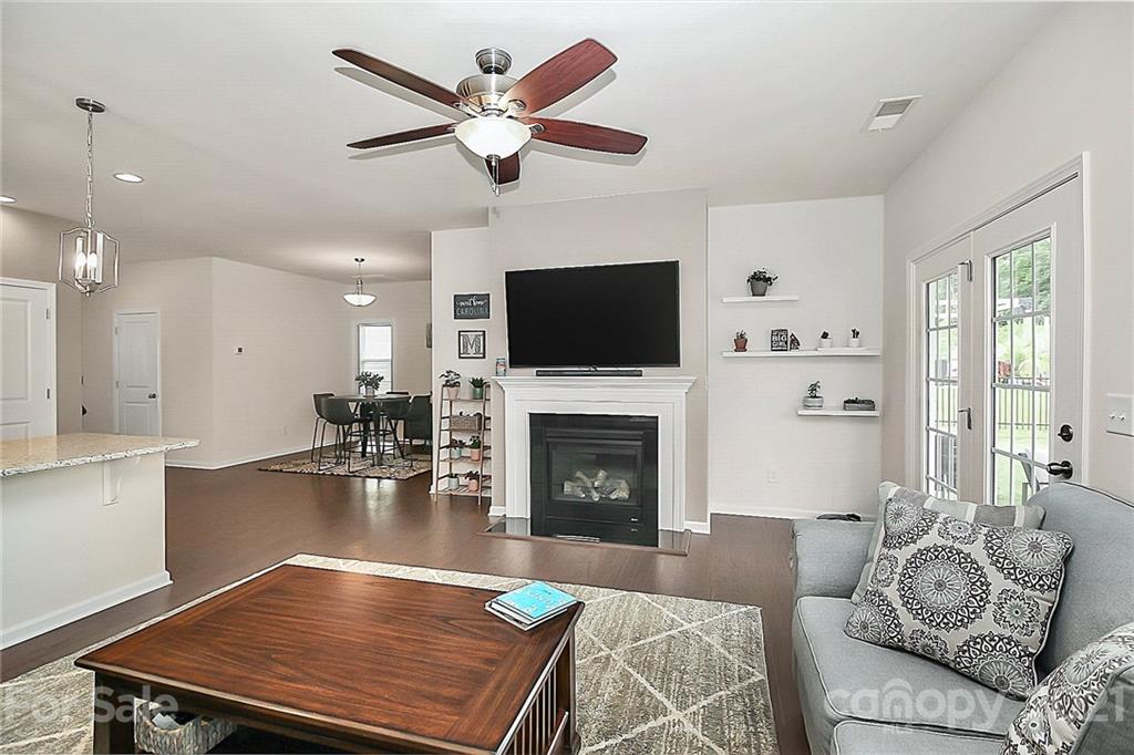 7131 Chrysanthemum Road Lancaster, SC 29720 - Photo 9 of 33 a living room with furniture a fireplace and a flat screen tv