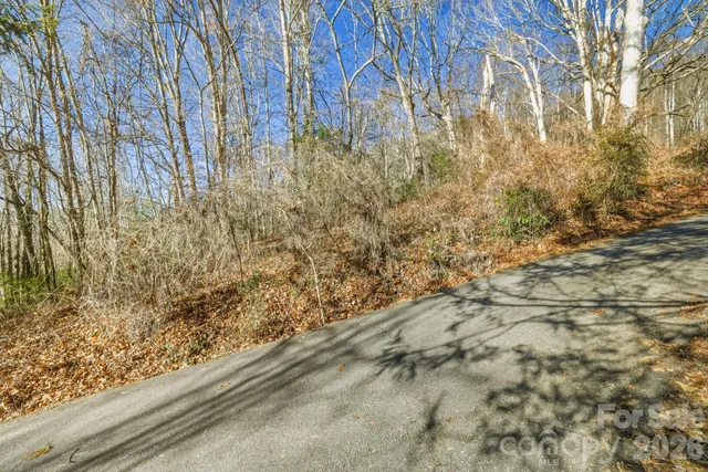 a view of a yard with wooden fence