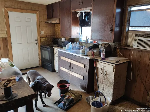 a kitchen with sink refrigerator and stove