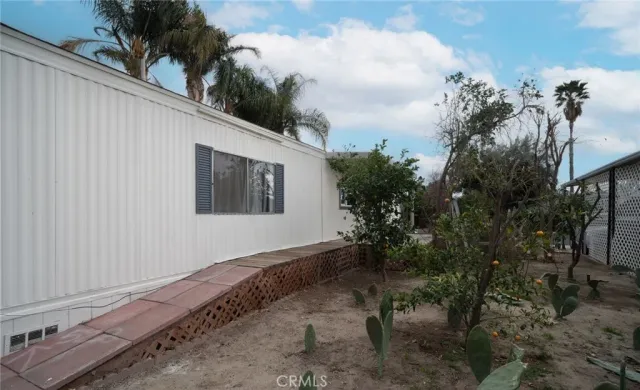 a backyard of a house with plants and trees