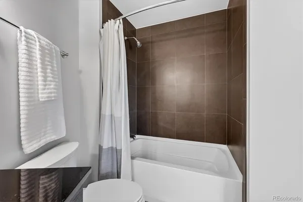 a bathroom with a shower and a toilet