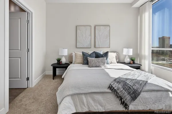 a bedroom with a bed and a night stand