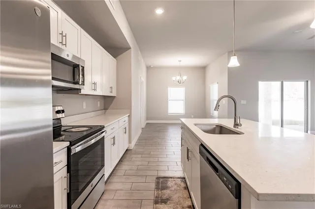 a kitchen with stainless steel appliances granite countertop a sink and stove