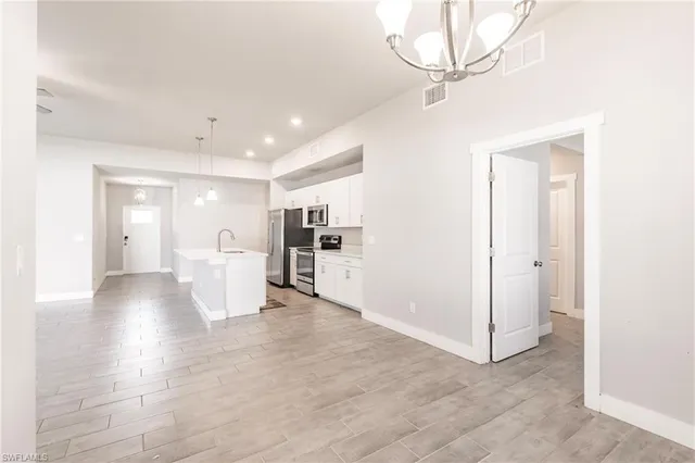 a view of a kitchen with a sink and a refrigerator