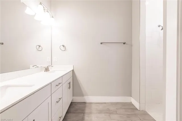 a bathroom with a double vanity sink and mirror