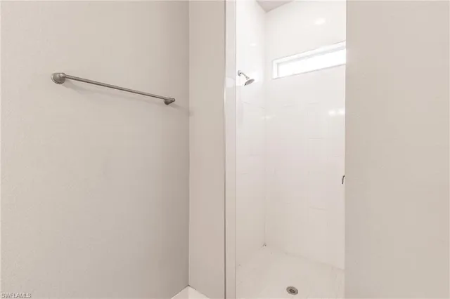 a bathroom with a glass shower door