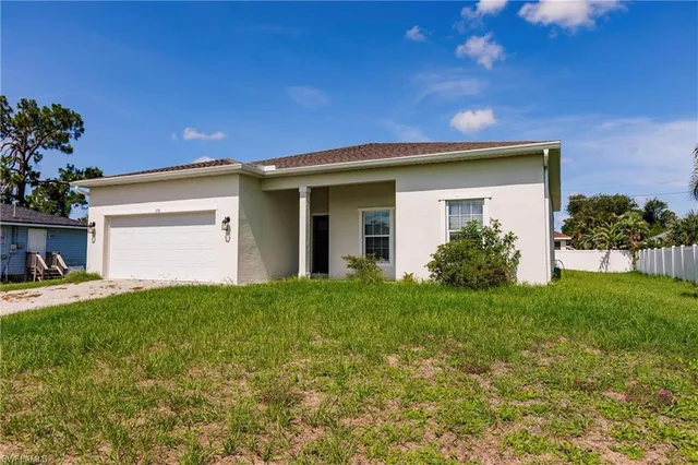 a view of a house with backyard and garden