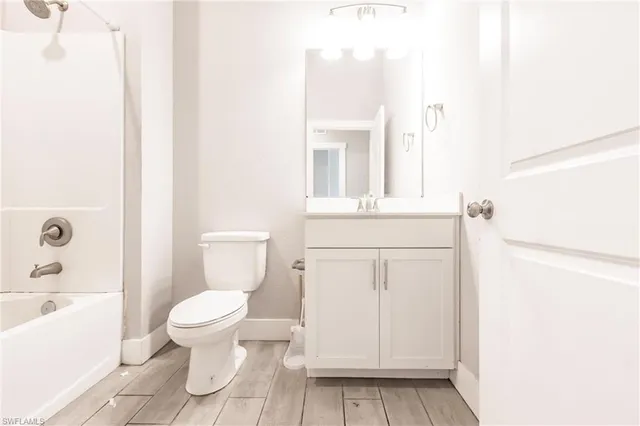 a white toilet sitting next to a bathroom sink