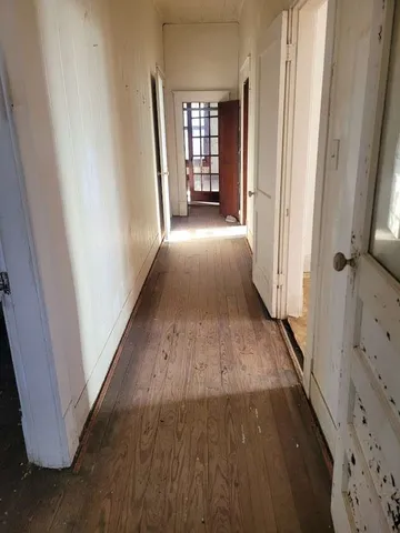 a view of a hallway view with wooden floor and staircase