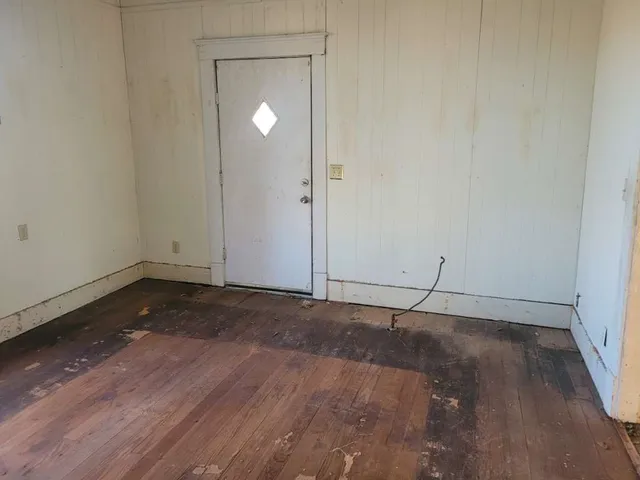 a view of a room with wooden floor