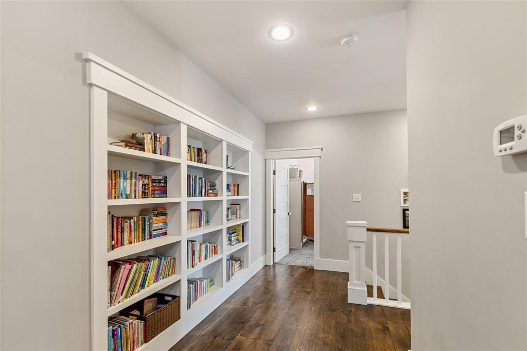 1109 East Oakdale Road Irving, TX 75060 - Photo 21 of 33 a living room with lots of books and a book shelf