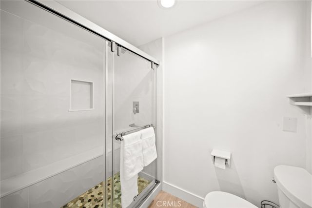 a bathroom with a shower and toilet
