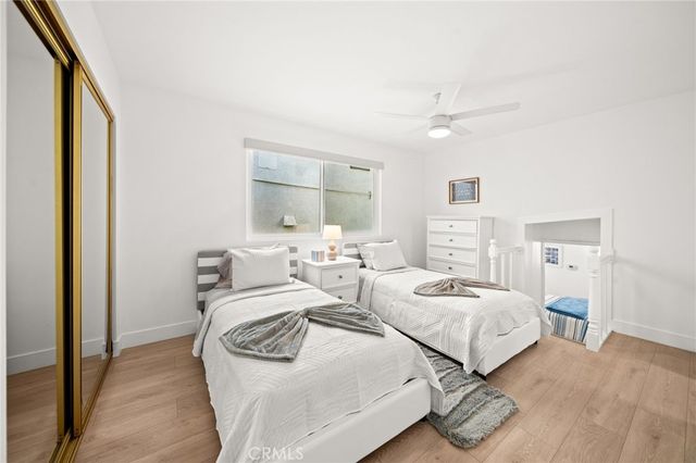 a bedroom with two beds and a dresser