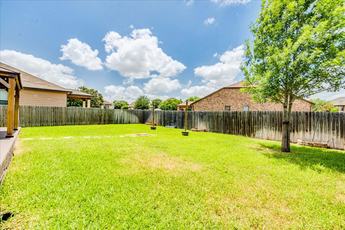 401 Waterleaf Boulevard Kyle, TX 78640 - Photo 28 of 28 Huge backyard with a patio the width of the home with a gazebo.