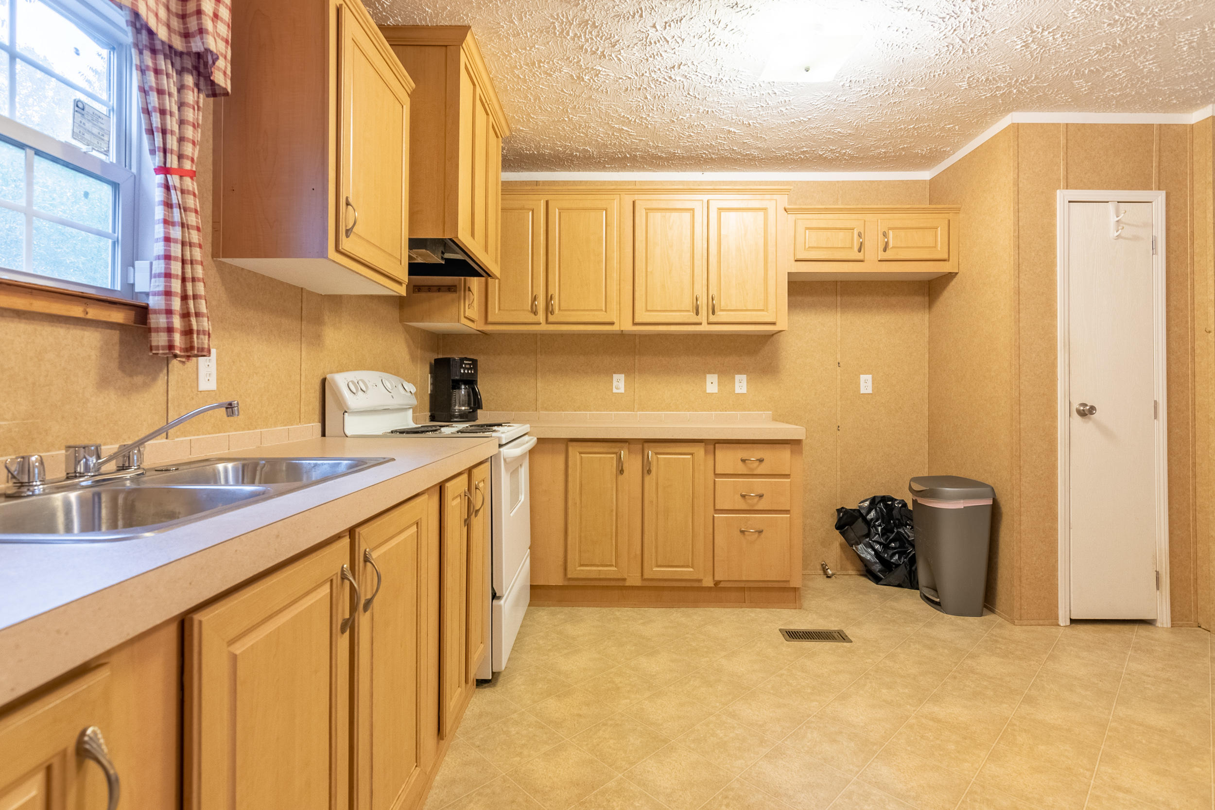 127 Millimeter Road Southwest Floyd, VA 24091 - Photo 12 of 31 a kitchen with a sink cabinets and a window