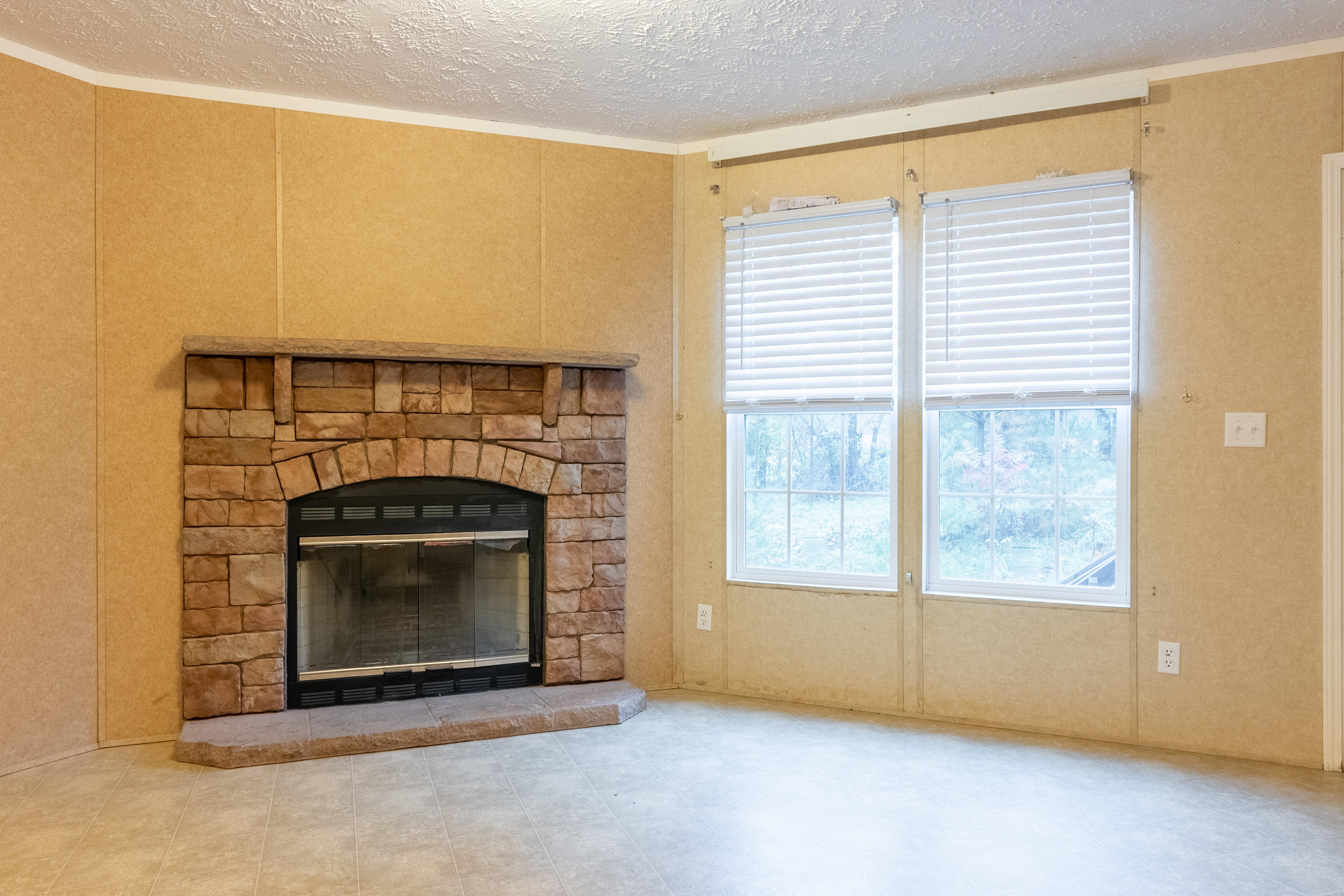 127 Millimeter Road Southwest Floyd, VA 24091 - Photo 7 of 31 a living room with a fireplace with a window
