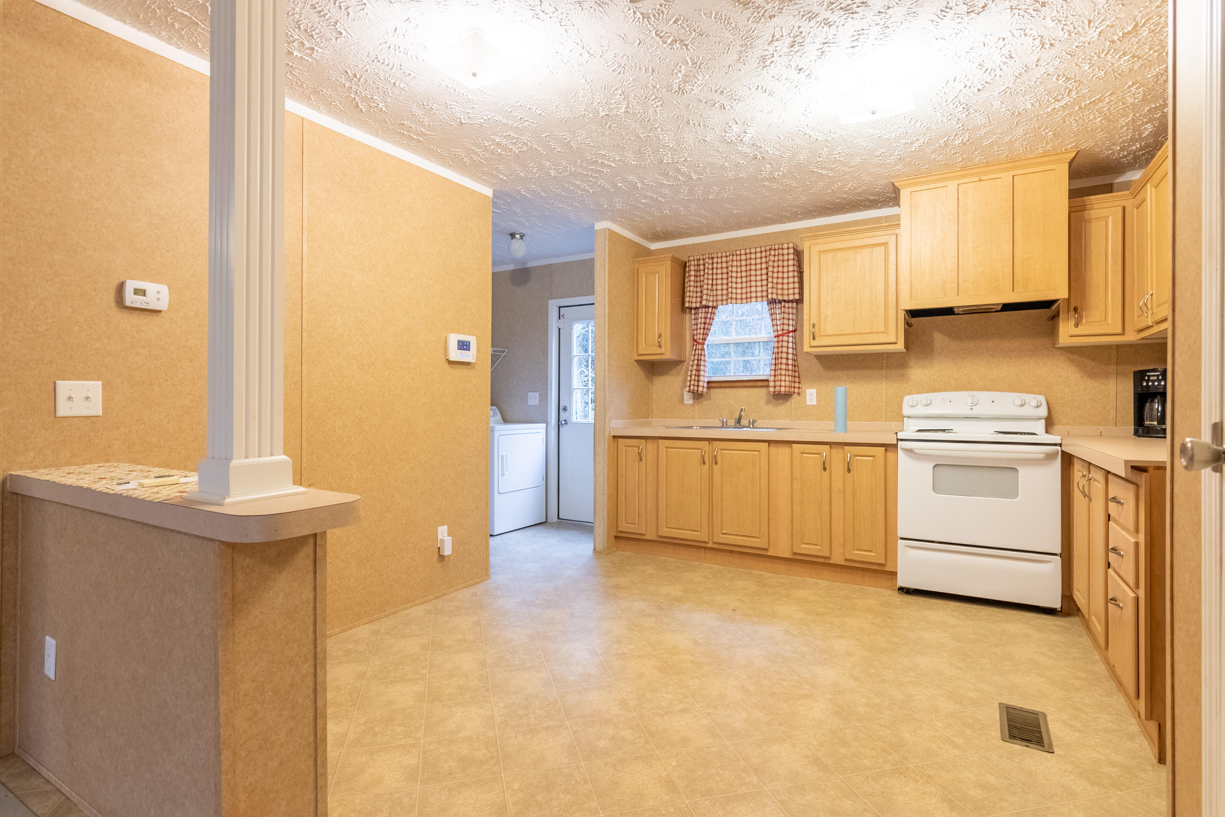 127 Millimeter Road Southwest Floyd, VA 24091 - Photo 8 of 31 a kitchen with white cabinets and white appliances
