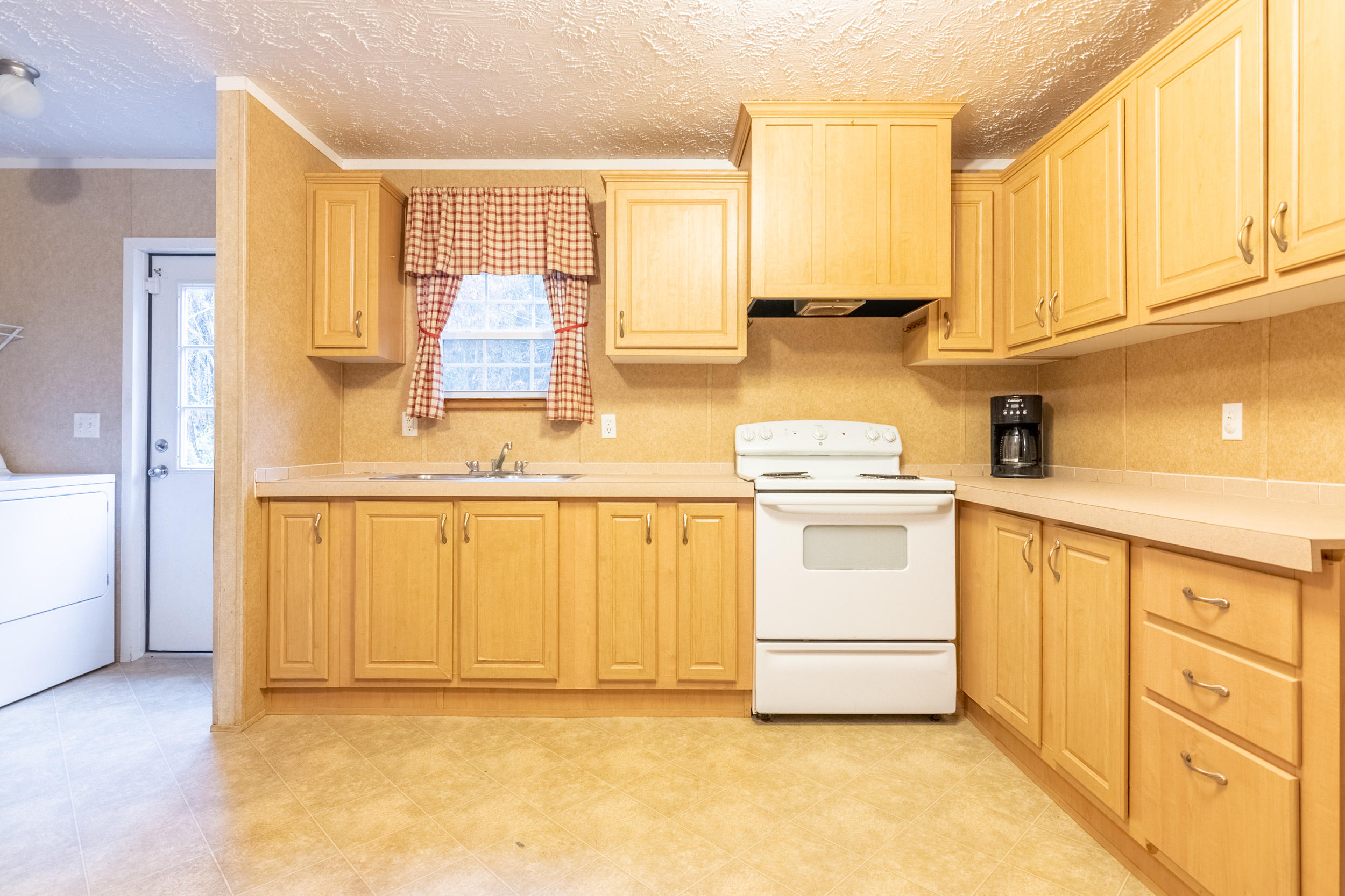 127 Millimeter Road Southwest Floyd, VA 24091 - Photo 10 of 31 a kitchen with granite countertop white cabinets and white appliances