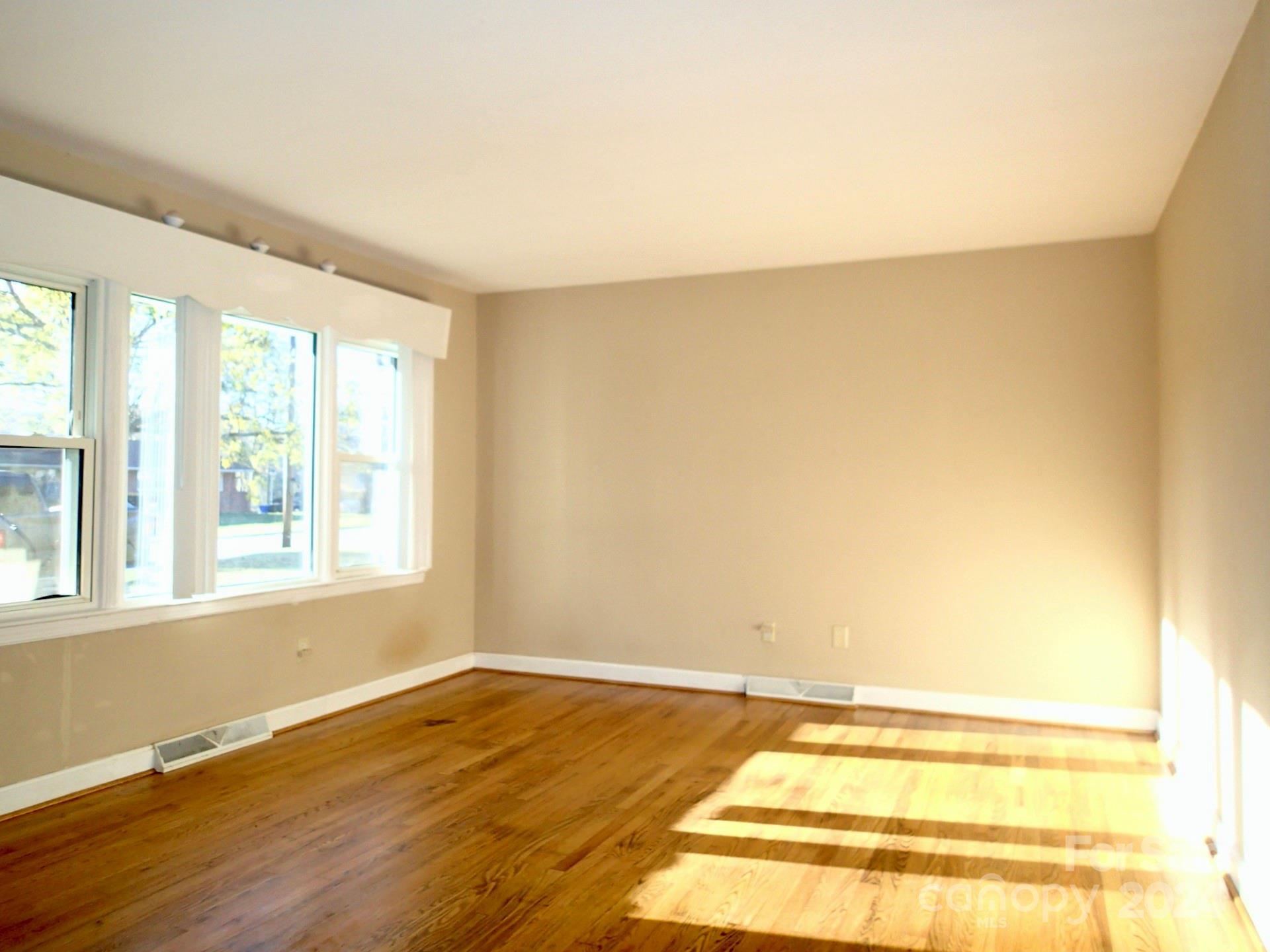 158 Crestview Street Rutherfordton, NC 28139 - Photo 11 of 34 a view of an empty room with wooden floor and a window